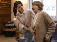 female caretaker in her client's house taking care of older person